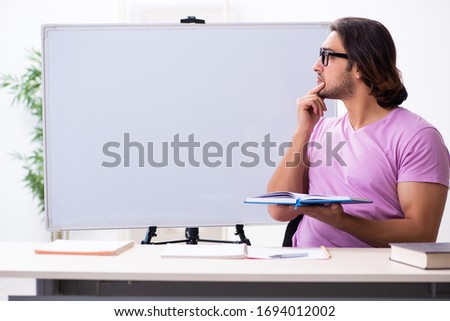 Young male student in the classroom