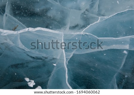 Transparent lake Baikal ice with cracks