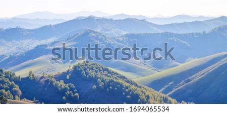 Evening haze in the mountains. Spring landscape. Panoramic view.