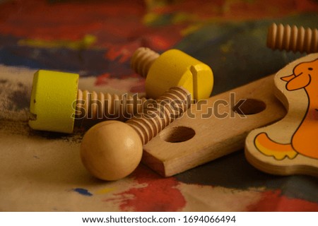 wooden toys on coloured painted paper