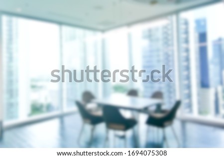 Blurred conference table in the office with the large glass window with city view Royalty-Free Stock Photo #1694075308