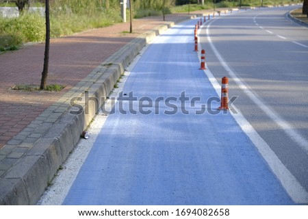 
blue white asphalt bike path