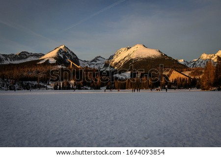 Frozen lake Strbske Pleso view by winter, Tatras mountains, Slovakia