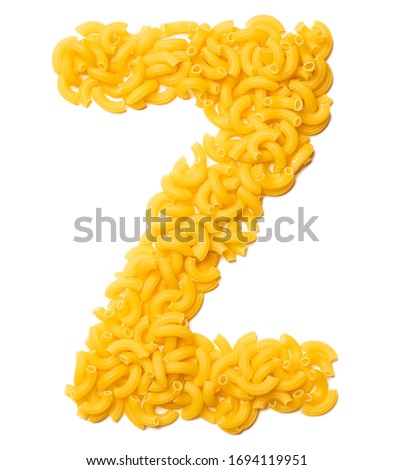 Letter Z of the English alphabet from dry pasta on a white isolated background. Food pattern made from macaroni. Bright alphabet for shops. 