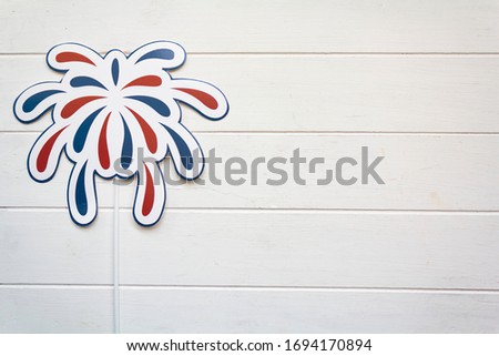 Fireworks props on white wooden table with copy space. USA holiday, 4 of July, celebration concept