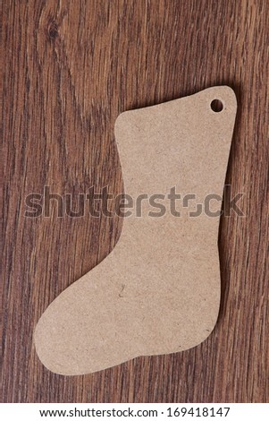 christmas boot with gifts on background wooden wall