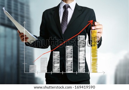 Business man hand drawing a graph 