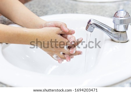 Young women wash their hands with soap to prevent bacterial and viral infections Corona or Covid-19, Inhibiting the spread and protection of the virus concept.
