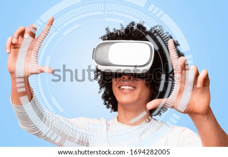 Creative collage of black millennial man in vr headset touching vitrual screen with data on light background, closeup