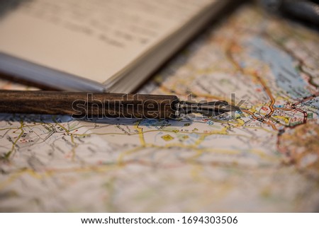 Book with a nib on an ancient Scotland's map.