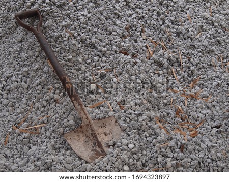 Old rusty shovel on dirty gravel. Shovel on gravel