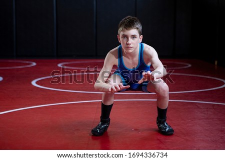 Youth wrestler  in a blue singlet