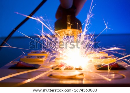 Hand connecting electrical plug cause electric shock, Idea for causes of home fire, Electric short circuit, Electrical hazard can ignite household items Royalty-Free Stock Photo #1694363080