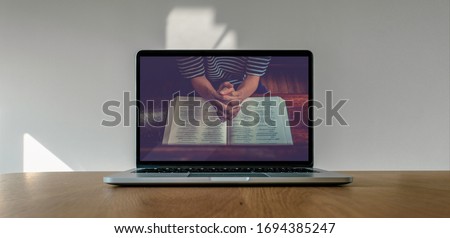 Worship from home, Online live church for sunday service, Laptop screen with close up prayer hands, quarantine for Covid 19 situation Royalty-Free Stock Photo #1694385247