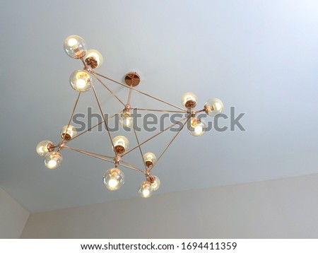 Vintage chandelier with a square frame on the ceiling.