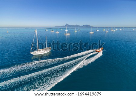 sailing yacht anchoring of Taina, Tahiti, French Polynesia with spectacular view on Moorea Island