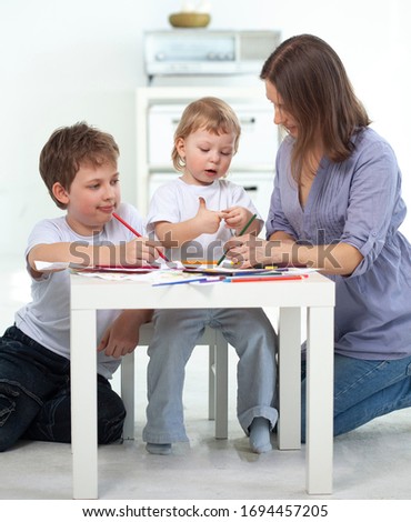 Happy family drawing pictures at home