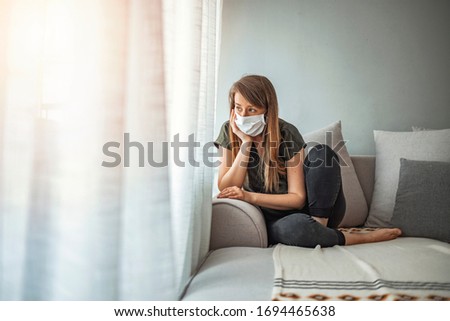 Woman in isolation at home for virus outbreak. Young woman in isolation at home for coronavirus. Woman in Isolation Quarantine Coronavirus. Sad lonely girl isolated stay at home Royalty-Free Stock Photo #1694465638