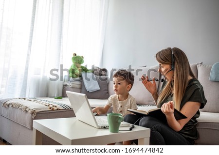 Mother working from home with kid. Children make noise and disturb woman at work. Homeschooling and freelance job. Moms Can Balance Work and Family. Multitasking mother working from home. 