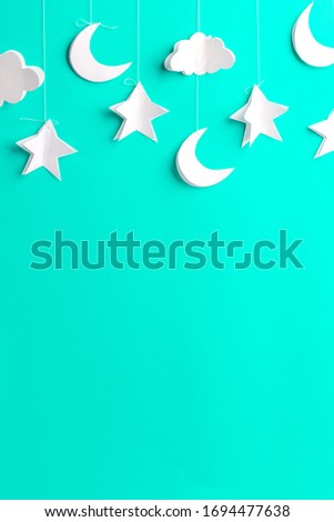 Mint background with new moon, stars and clouds of paper, handmade, free space for your text
