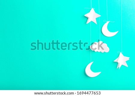 Mint background with new moon, stars and clouds of paper, handmade, free space for your text