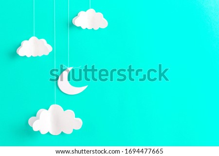 Mint background with new moon and clouds of paper, handmade, free space for your text