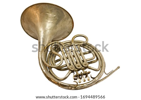 Old vintage golden French horn on a white background, isolated