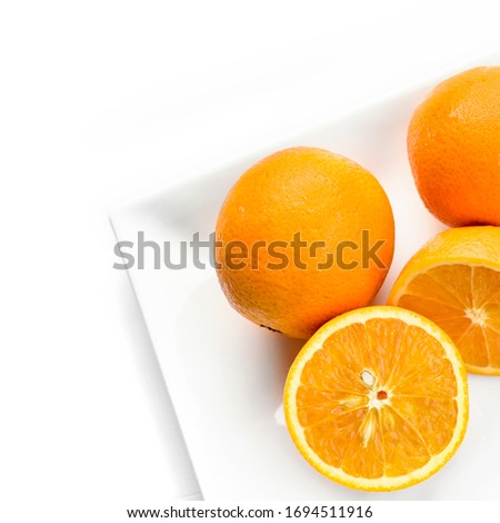Fresh whole orange and slices isolated on white background. From top view