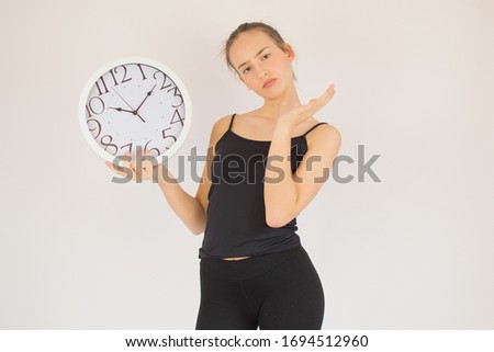 Young beautiful girl with big clock