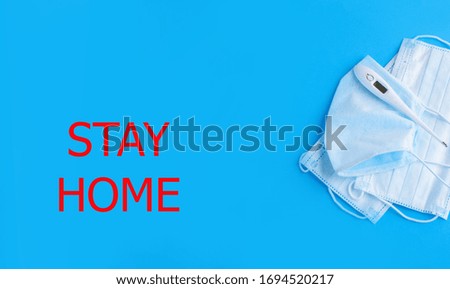 Medetsin content with a thermometer, face masks, on a blue background. Stay home