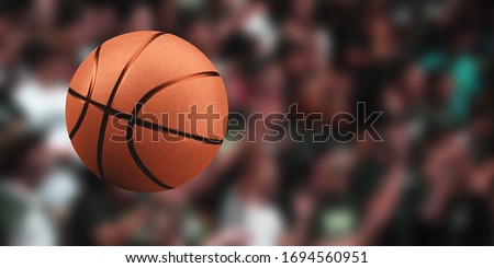 Basketball ball on a blurred background of a crowd of people. Sport competitions.