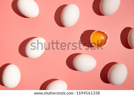 White chicken eggs on pastel pink color background isolated. Easter holiday minimal food concept. Hard light. Empty space fashion template.