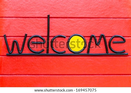Welcome text sign, greeting concept on Red Wood Wall