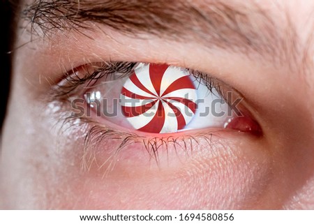 hypnotic eye effect, the macro view of the addicted person with spinned lines in eye