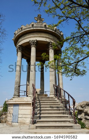 Parc des Buttes-Chaumont - Public Park situated in northeastern Paris. France. Stone gazebo - Temple de la Sibylle, inspired by the Temple of Vesta in Tivoli.