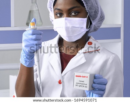 Portrait of African female medical student, woman scientist In white gown, plastic hat, gloves, mask holds pipette, test for pcr nucleic acid dna corona virus, diagnostics of covid-2019 SARS-CoV-2.