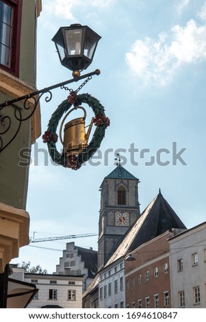 Old historic Shop Sign beneath a Street Lamp in Wasserburg City, Bavaria/Germany