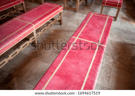 Wooden benches with red cloth