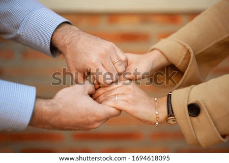 Hands of a couple with rings as a sign of love