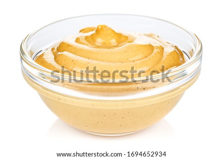 Mustard in a small transparent glass round bowl isolated on white background Royalty-Free Stock Photo #1694652934