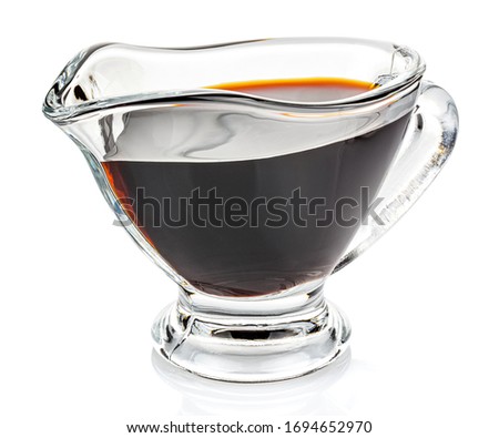 Soy sauce in a transparent glass gravy boat isolated on white background Royalty-Free Stock Photo #1694652970