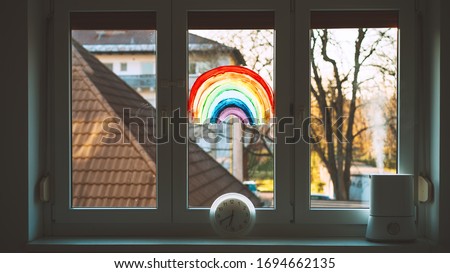 Close-up photo of painting rainbow on window. Rainbow painted with paints on glass is a symbol for many meanings.