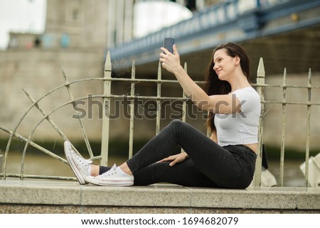 young woman taking a selfie outdoors.