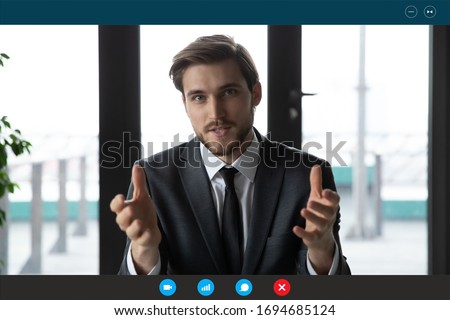 Head shot of confident businessman in suit talk with partner company client or investor use video call app, laptop screen view. Easy comfort negotiations distantly, coach provide info remotely concept Royalty-Free Stock Photo #1694685124