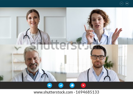 Pc screen webcam view, head shot portrait four diverse medical workers in white coats take part in distant talk, engaged in group video call. Videoconferencing, concilium remote communication concept Royalty-Free Stock Photo #1694685133
