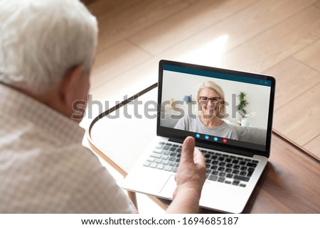 Pc screen webcam view 60s daughter chat with 70s dad by video call relatives share news show warm relation enjoy distant communication on-line. Old generation easy comfort usage of modern app concept Royalty-Free Stock Photo #1694685187