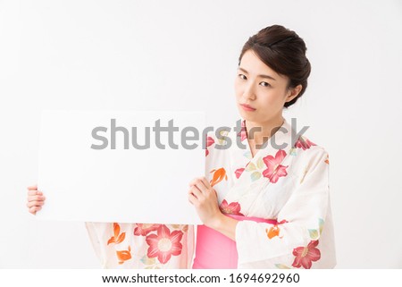 attractive asian woman wearing traditional Japanese casual summer kimono called "Yukata",white board, think,