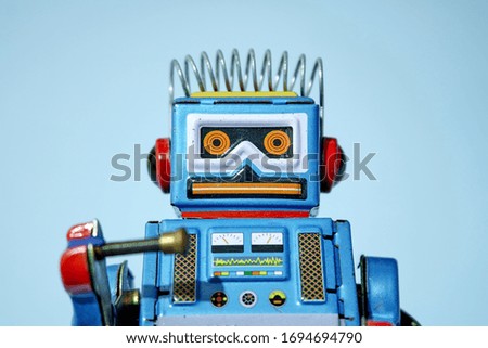 A studio photo of a toy robot