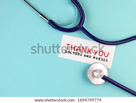 medical stethoscope and the inscription Thank you to doctors and nurses on a blue background. concept of gratitude to medical workers during the coronavirus pandemic