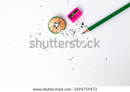 Color pencils with sharpener on white background.